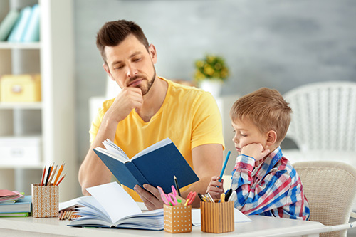 Father and son doing homework together